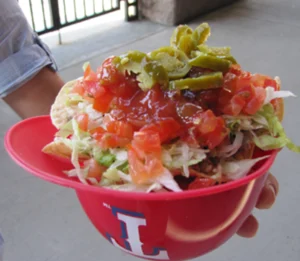Nachos with toppings in a red helmet.