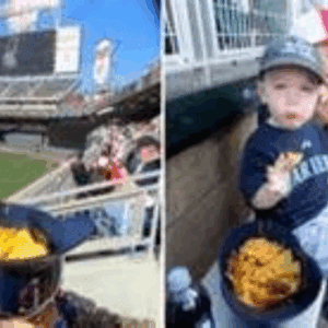 Child at baseball game with glove and cap.